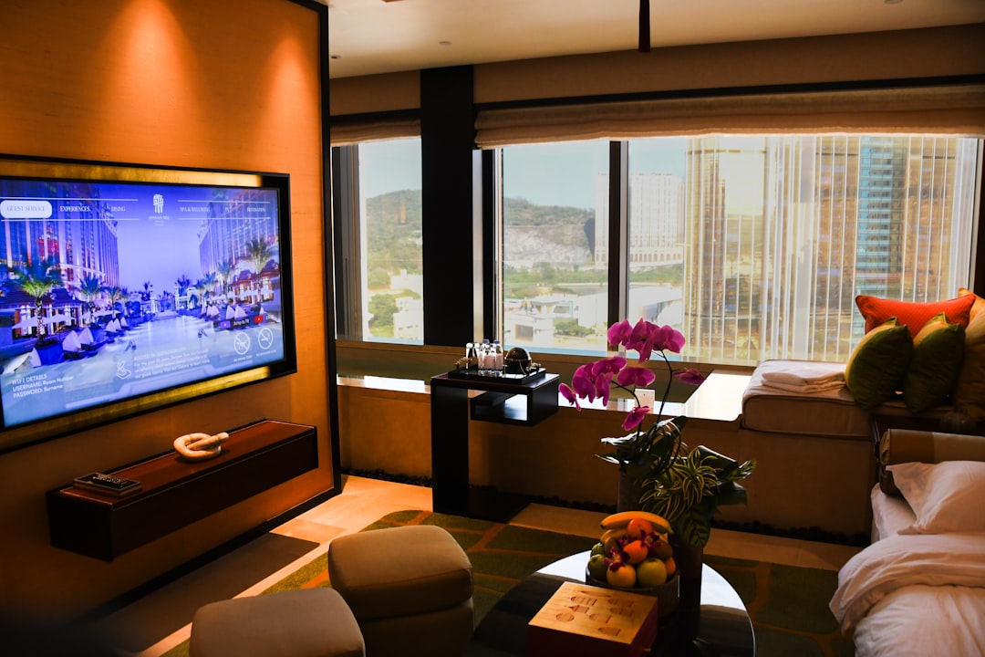 Luxurious hotel room with city view and large television - Photo by Dynamic Hong Kong on Unsplash